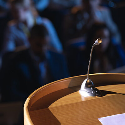 close-up-of-podium-with-speaker-in-auditorium-2023-11-27-05-37-10-utc