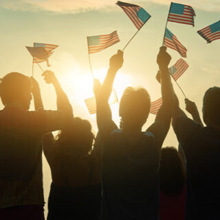 silhouettes-of-people-holding-the-flag-of-usa-2023-11-27-05-33-21-utc